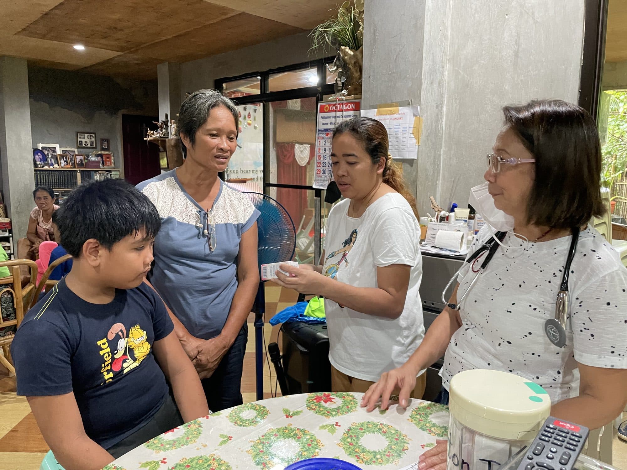 A clinic nurse talks with a family